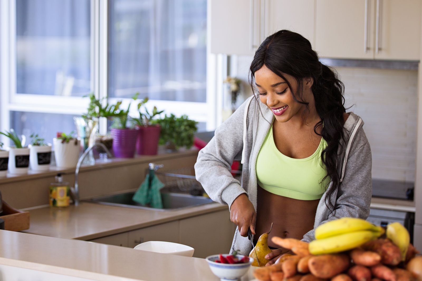 Woman preparing a healthy meal in her kitchen