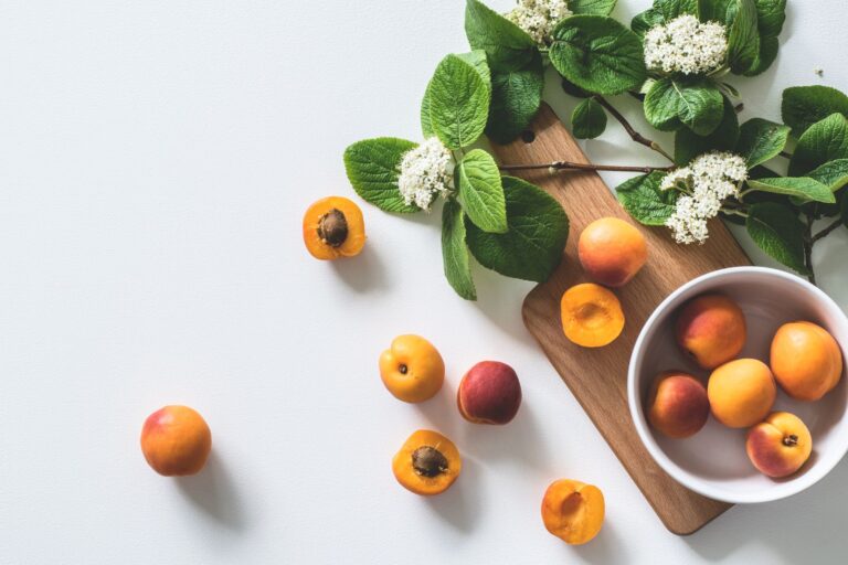 Fresh peaches and fruit on a wooden board