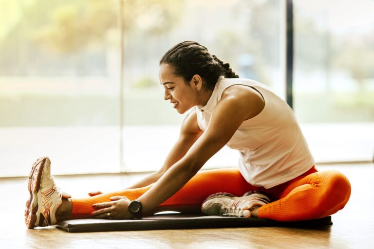 Woman stretching on an exercise mat at home