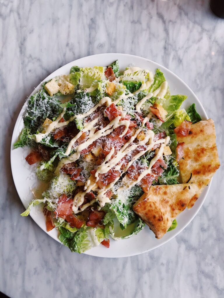 Healthy salad plate with grilled protein and dressing