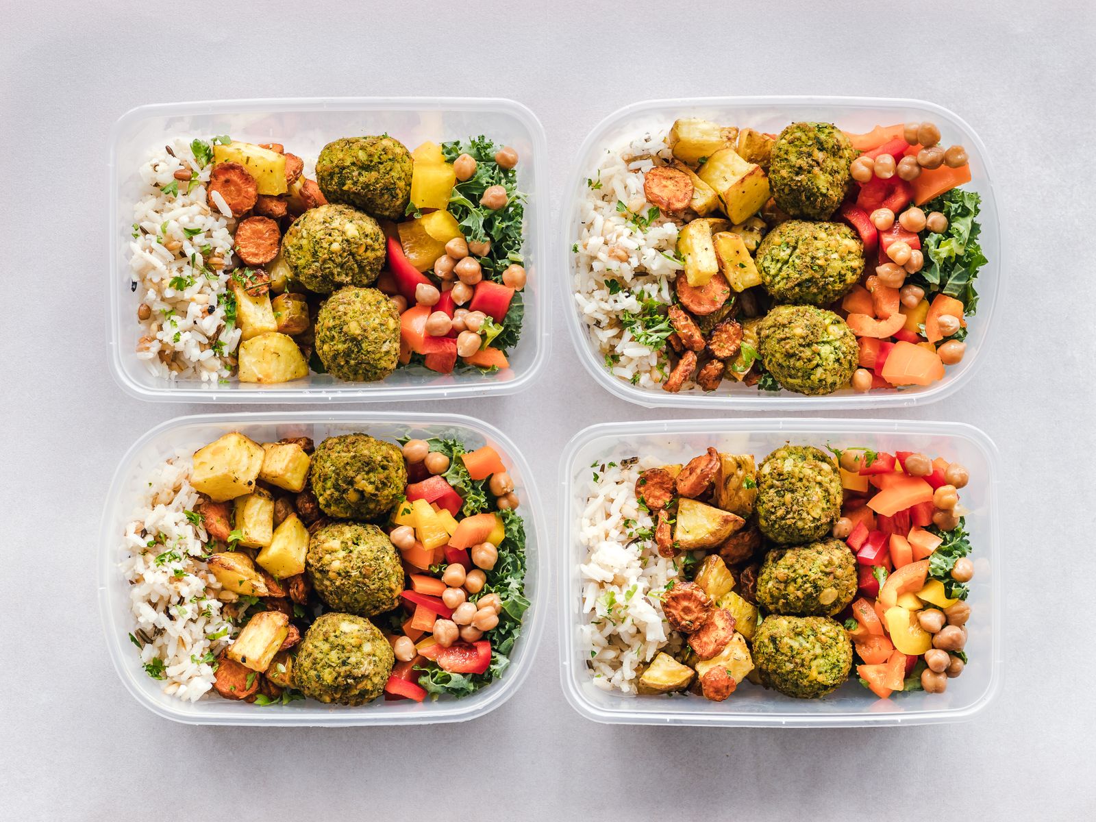 Meal prep boxes with falafel, grains and vegetables