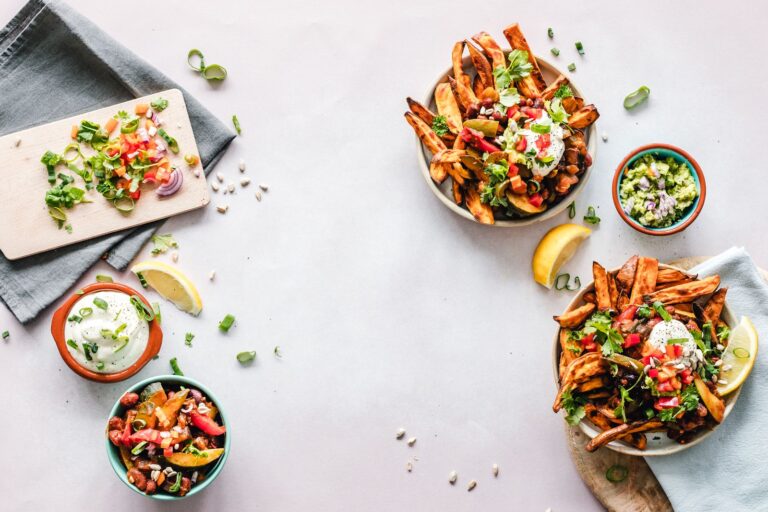 Several healthy salad bowls on a white table