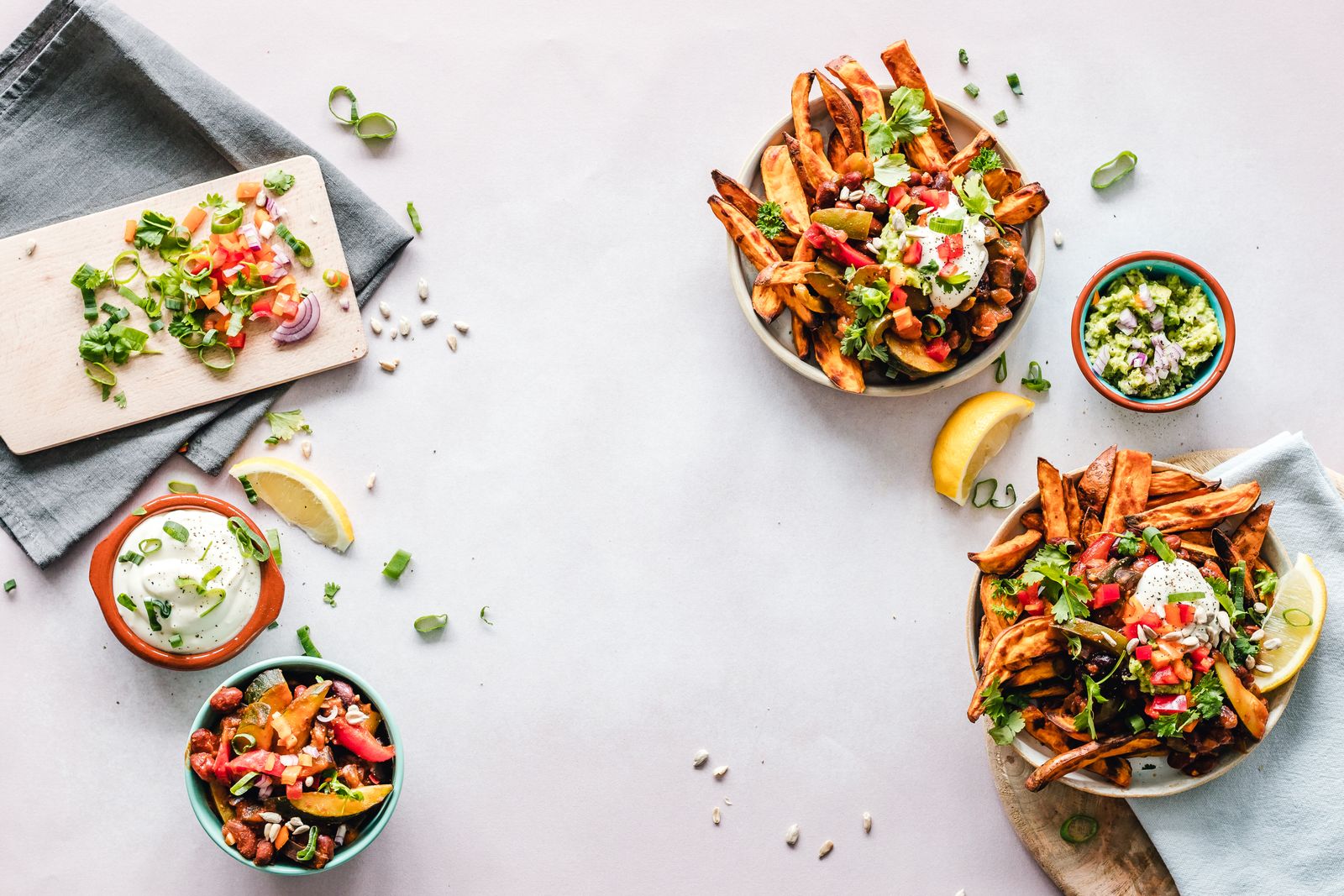 Several healthy salad bowls on a white table