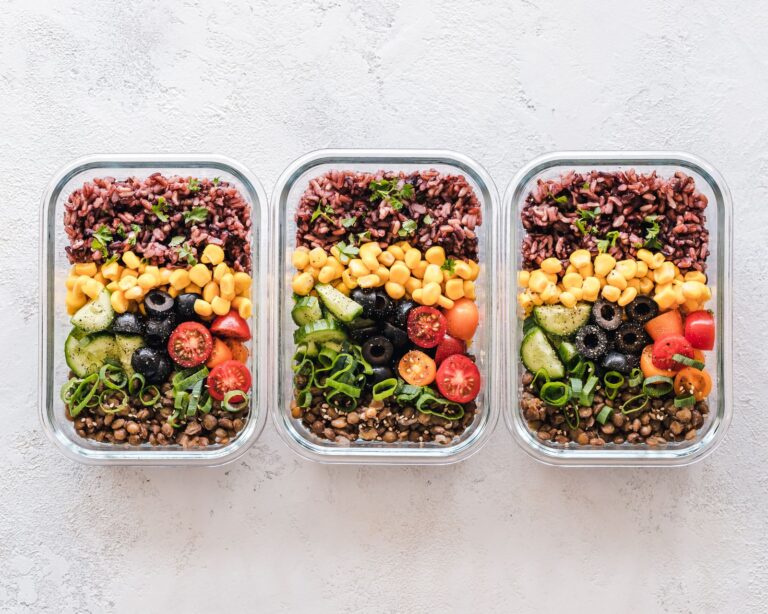 Healthy meal prep containers with vegetables, grains and protein