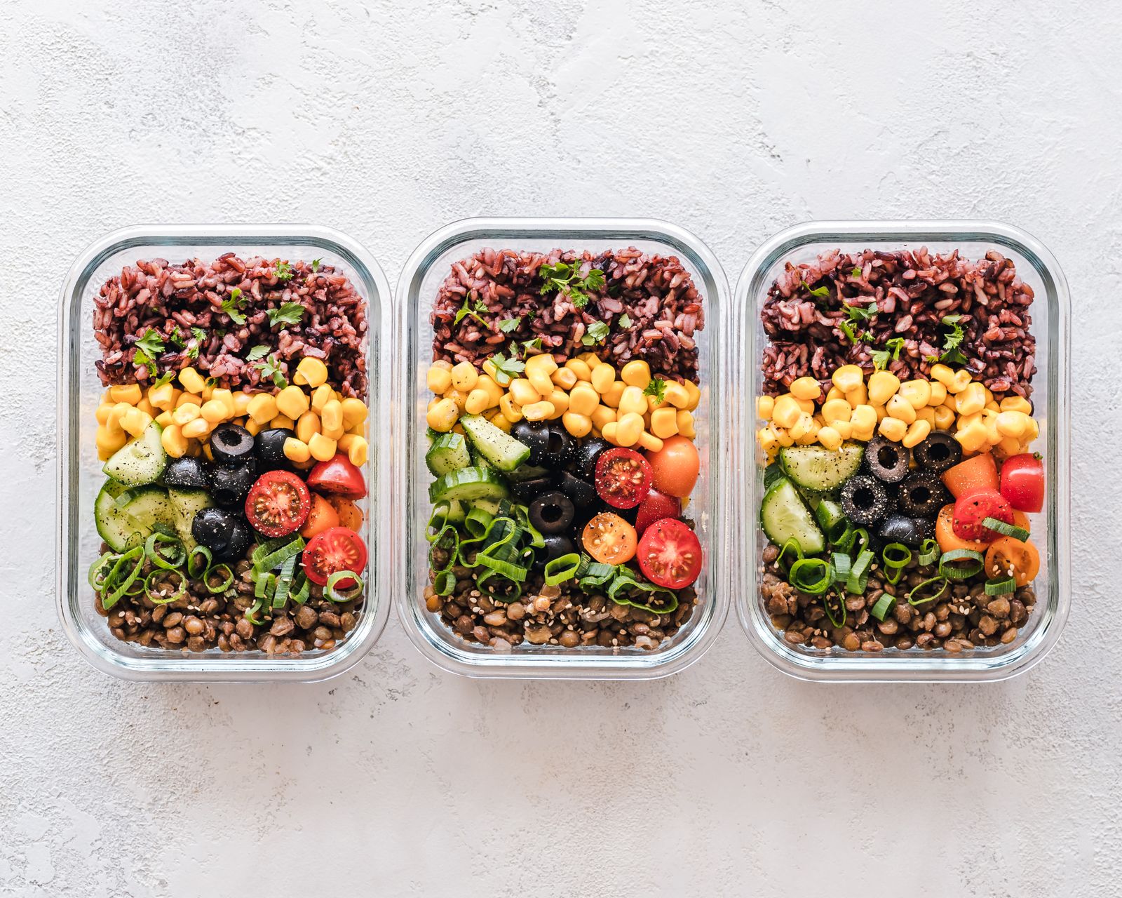 Healthy meal prep containers with vegetables, grains and protein
