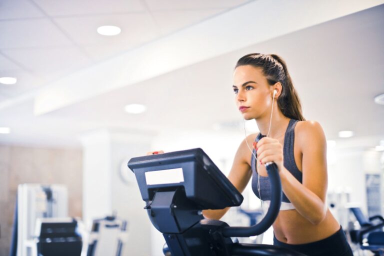 Woman walking on a treadmill at the gym