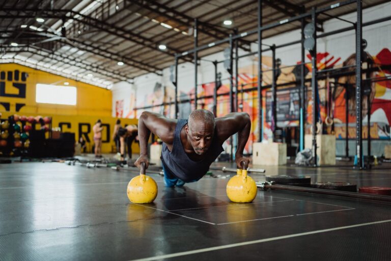 Man doing a bodyweight upper-body exercise in a gym
